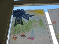 The Best of Kittitas County Coloring Contest Entry - Drawing of a camping scene with a tent in the woods, fox, and a fire