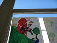 The Best of Kittitas County Coloring Contest Entry - Drawing of a girl riding a horse with a lasso in front of a red barn