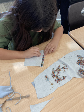 Student working on a beading project in the Ellensburg School District Native American/Alaskan Native cultural program.